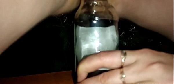  Seductive stepmom masturbates with a bottle before fucking